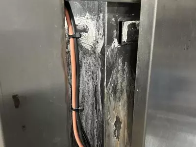 Original leaking water tank on Nilfisk Delta Booster multi-pump pressure washer system before replacement.